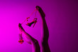 © Global News Art - Red or orange high heels shoes and sexy black woman legs on pink background.