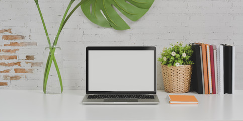 Comfortable designer workplace laptop computer and office supplies