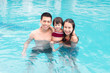 © makistock - Happy parents. Happy good-looking parents feeling unbelievable swimming in pool with daughter