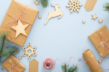 christmas or winter composition. frame made of gift box, wrapping paper, wooden decorations, fir tre