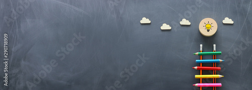 Fotomural Education concept of Ladder made from pencils next to clouds over blackboard