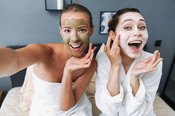 Poster - Women taking care of their skin take selfie by camera.