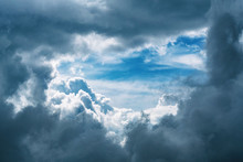 Panoramic View Of Stormy Dark Cloudscape And Clouds Gap With Blue Sky Background