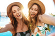 Two cheerful beautiful young girls wearing swimwear
