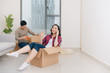 © makistock - Happy young couple moving in their new apartment, having fun and riding in cardboard boxes at new home