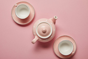 Canvas Print - Pastel pink dotted teapot and cups with saucers on pink background