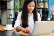 © chayathon2000 - Asian woman using credit card shopping online in coffee shop cafe