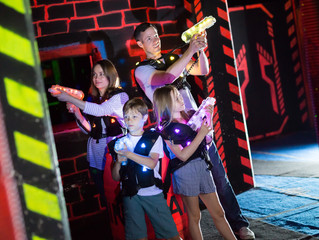 Wall Mural - Kids with parents during lasertag game