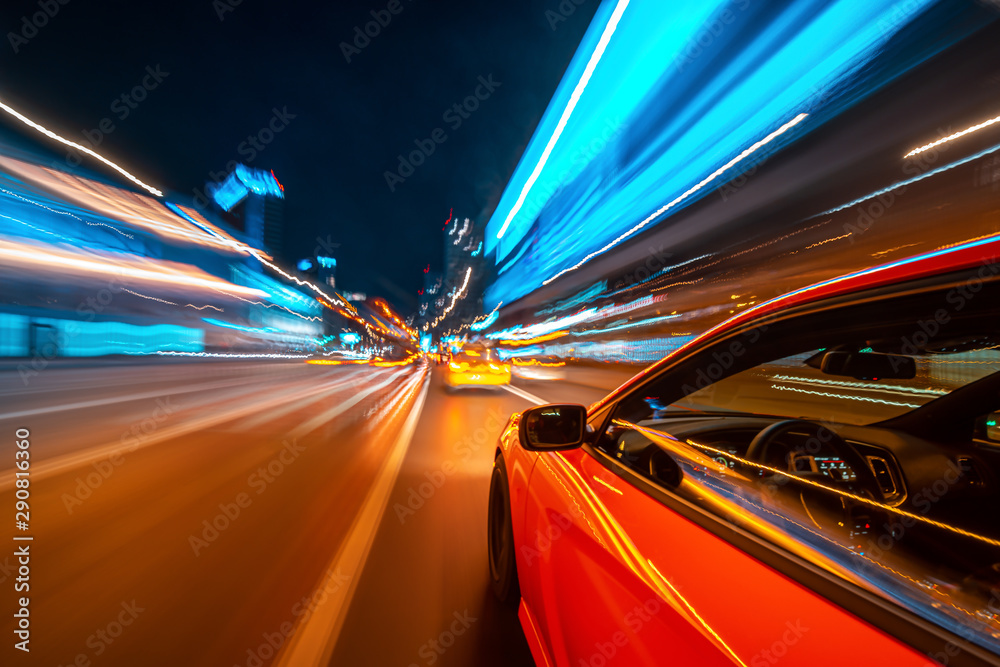 View from Side of a Red Muscle Car moving in a night city, Blured road ...