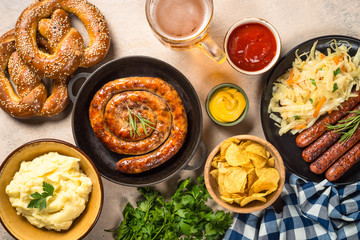 Wall Mural - Oktoberfest food - sausage, beer and bretzel.