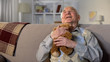 © motortion - Happy senior man hugging teddy bear, remembering grandchildren, family care
