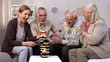 © motortion - Active elderly people playing block game, spending time in friendly atmosphere