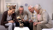 © motortion - Happy mature people playing board game together nursing home, pension free time