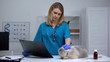 © motortion - Female veterinarian sadly looking at cat holding x-ray, terminally ill pet