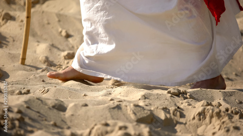 Prophet legs walking on sand, following of Jesus faith, religious conversion