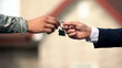 © motortion - Man in business suit giving house key to man in military uniform, state support