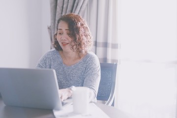 Wall Mural - senior woman working on laptop at home