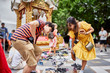 thai tourist couple removing shoes before walking into temple