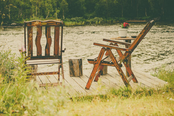 Canvas Print - Rest stop area picnic chaires on fjord lake shore