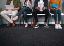 Low Section Of Job Applicants Waiting In Corridor Preparing For Recruiting Process - Photo Of Diverse Feet Sitting In A Row Waiting For Job Interview