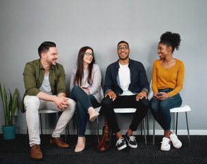 Poster - Diverse group of friends sitting on chair waiting in queue smiling and enjoying together - young group of friends experiencing a sense of belonging and inclusion and connection