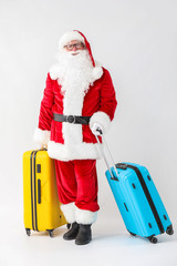 Wall Mural - Santa Claus with luggage on white background