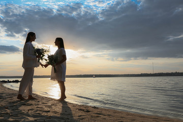 Canvas Print - Beautiful lesbian couple on their wedding day near river