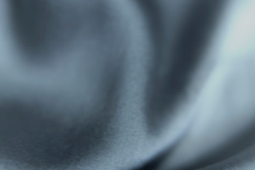 blurred ghrey background. closeup of silk fabric