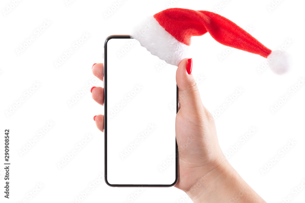 Female hand holding mobile smart phone with santa hat isolated on white ...