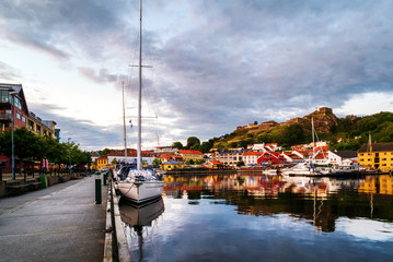 Wall Mural - View of the illuminated houses and yachts with Fredriksted fortress at the background in Halden, Norway