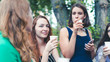 © creative_content - Group of girlfriends toasting with champagne in paper glass. Young people celebrating with champagne at party outdoors. Concept of hen-party