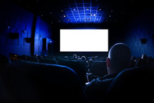 Cinema Or Theater In The Auditorium. People Watching A Movie. Mockup With White Blank Screen