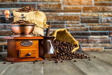 Still Life With Coffee Beans And Old Coffee Mill On The Wooden Background,coffee Grinder,coffee Accessories Brown Clay Cup Vintage Wooden Mill And Sack With Beans Scoop On Old Wood Background