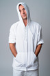 © Ranta Images - Portrait of handsome Hispanic man wearing hooded shirt