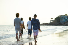 Four Young Asian Adult Walking On Beach
