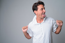 Portrait Of Happy Handsome Hispanic Man Sticking Tongue Out