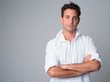 © Ranta Images - Portrait of handsome Hispanic man thinking with arms crossed