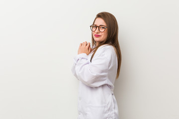 Wall Mural - Young doctor woman against a white wall scared and afraid.