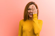 © Asier - Young pretty young woman having fun covering half of face with palm.