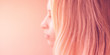 © Omega - female pink hair on a pastel background, side view portrait with blurred face.