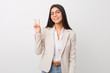 Young business arab woman isolated against a white background joyful and carefree showing a peace symbol with fingers.