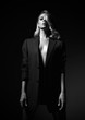 © Dmitry Lobanov - Self-confident impudent young blonde woman in formal jacket over her naked body is standing with her head high up