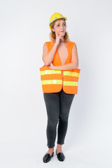 Wall Mural - Portrait of beautiful blonde woman construction worker thinking