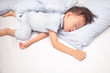 © yAOinLoVE - Cute little Asian 3 - 4 years old toddler boy kid in pajama sleeping / taking a nap on a blue pillow in bed , Bedtime for kids concept with copy space