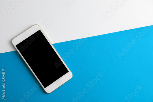 Fotografía Modern phone on color background, top view. Space for text