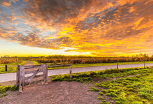 Beautiful Colorful Sunrise With Low Sun During Autumn In The Nature Reserve Bentwoud South Holland, The Netherlands With Entrance Gate
