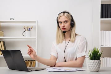 Close-up portrait of a customer service agent sitting at office