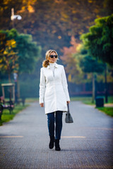 Wall Mural - middle-aged woman walking in city park