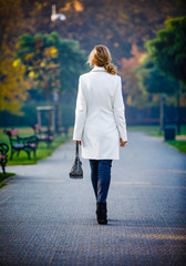 Wall Mural - middle-aged woman walking in city park