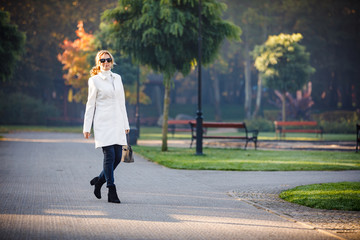 Wall Mural - middle-aged woman walking in city park